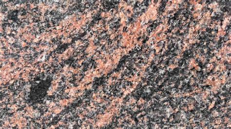 Indian Aurora granito tekstūra su raudonais ir oranžiniais raštais