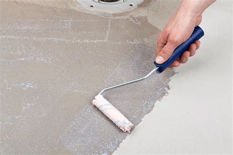 Gruntavimas plytelių paviršiaus prieš klijavimą